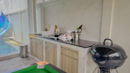 a kitchen with a counter top with a mixer at Wana Villa ChaAM in Cha Am