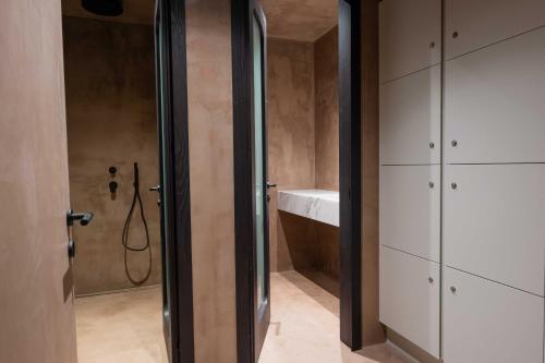 a bathroom with a shower and a sink at Noir Mykonos in Mýkonos City