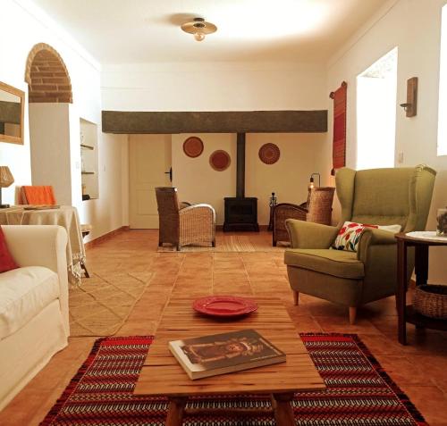 a living room with couches and a table at Casa da Vila in Mourão