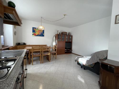 a kitchen and dining room with a table and a dining room at 063 Bilocale, Carisolo in Carisolo