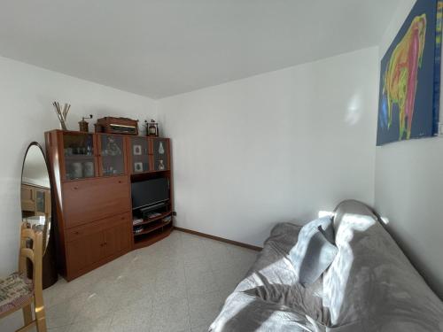 a bedroom with a bed and a tv in a room at 063 Bilocale, Carisolo in Carisolo
