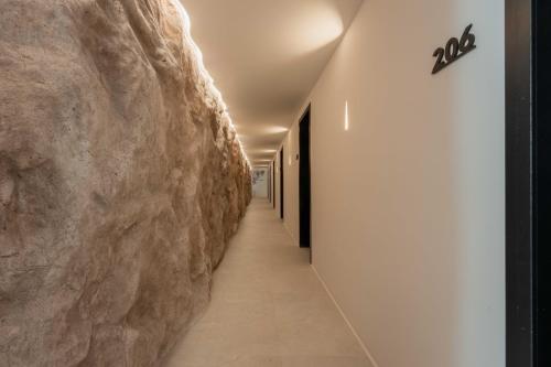 a hallway with a stone wall in a building at Noir Mykonos in Mýkonos City