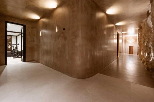 a hallway of a house with a stone wall at Noir Mykonos in Mýkonos City
