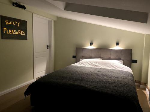 a bedroom with a bed with two lights on it at A cozy spot near the central park in Bistriţa