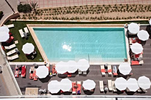 an overhead view of a pool with white tables and chairs at Son Moll Sentits Hotel & Spa - Adults Only in Cala Ratjada
