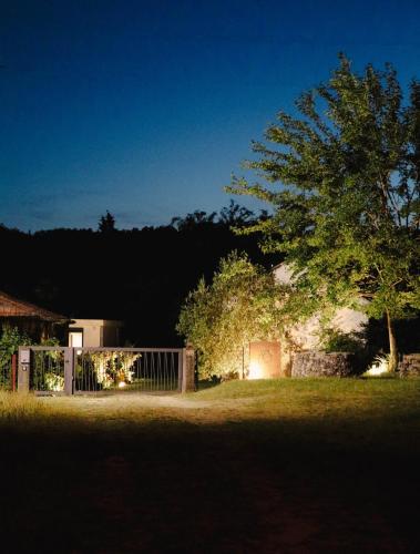 a house with a gate and a tree in the yard at Casa L in Ulcinj