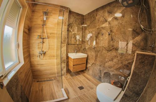 a bathroom with a shower and a toilet and a sink at MAKIS Luxury Apartments City Center Free Parking in Ohrid