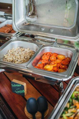 a buffet with food in trays on a table at The Kala in Amphoe Koh Samui