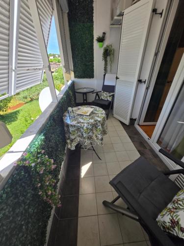 a balcony with a table and chairs on it at Jasna - apartman studio in Pula