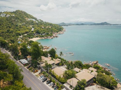 an aerial view of a town next to a body of water at The Kala in Amphoe Koh Samui