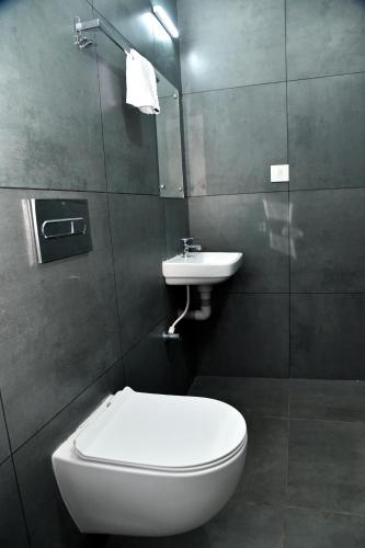 a bathroom with a toilet and a sink at Ayush Green - Home Away Home in Chakkarakkal