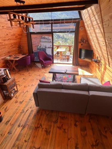 a living room with a couch and a table at İrem Bungalow in Trabzon