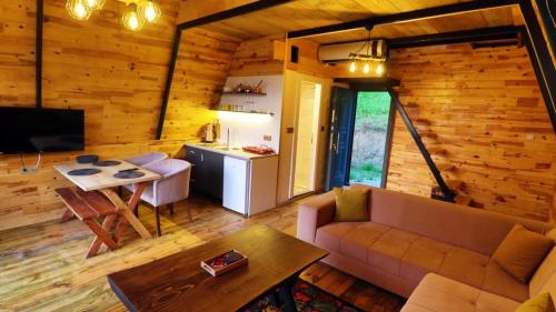 a living room with a couch and a table at İrem Bungalow in Trabzon