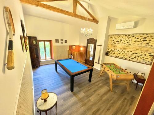 a room with a ping pong table and a game at " Ô Chai Nous " 14 pers - Billard, Babyfoot - Structure de Jeux in Poucharramet