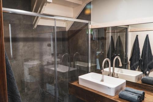a bathroom with two sinks and a mirror at La Borda del Gato Rafa in Vielha