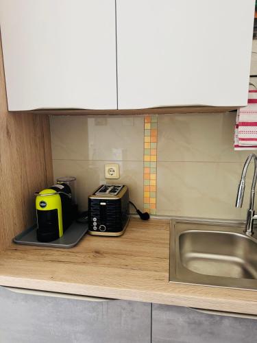 a kitchen with a counter with a toaster and a sink at Casa Mare in Rabac