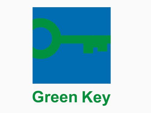 a blue and green key with the words green key at Grand Hotel Bregenz - MGallery Collection in Bregenz