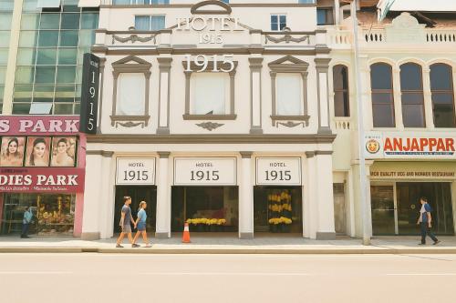 a building on a street with people walking in front of it at Hotel 1915 Chinatown Kuala Lumpur in Kuala Lumpur