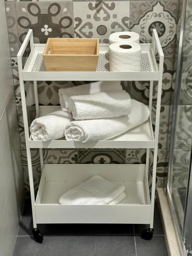 a white shelf with towels on it in a bathroom at Casa M- Studio #1 - Brand New in Herceg-Novi