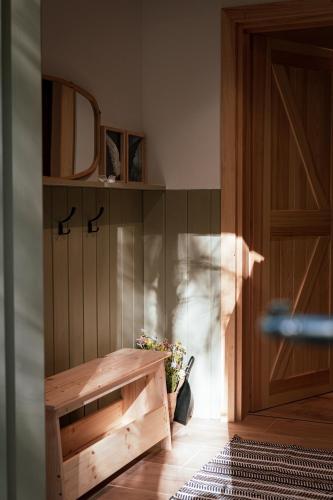a room with a wooden door and a vase of flowers at Leśne Anioły in Czarna