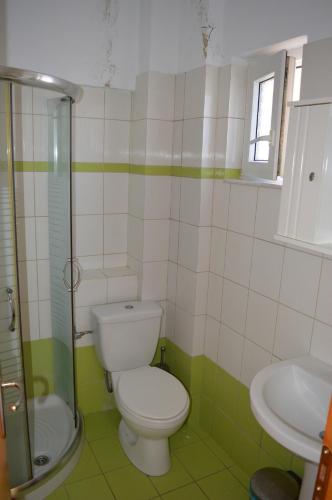 a bathroom with a toilet and a sink at Effie's Vacation House in Kanali