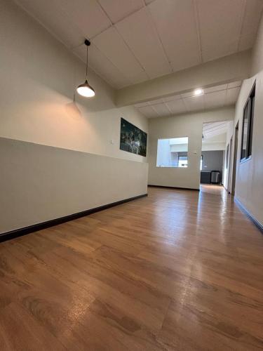 an empty room with a wooden floor and white walls at 2-16 pax 5BR, 4 bathrooms, 5km to TC beach in Kuantan
