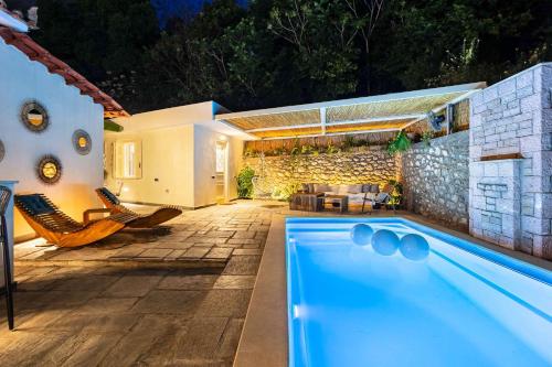 a swimming pool in the backyard of a house at The Secret Garden - Courtyard & Private Pool Villa in Kalamata