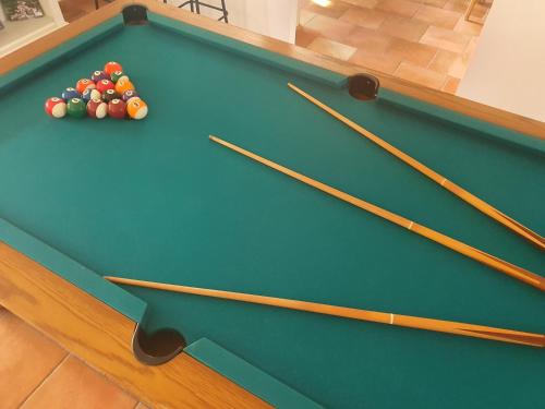 a pool table with cue balls on top of it at Gîte des Falaises 10 à 12 personnes in Souspierre
