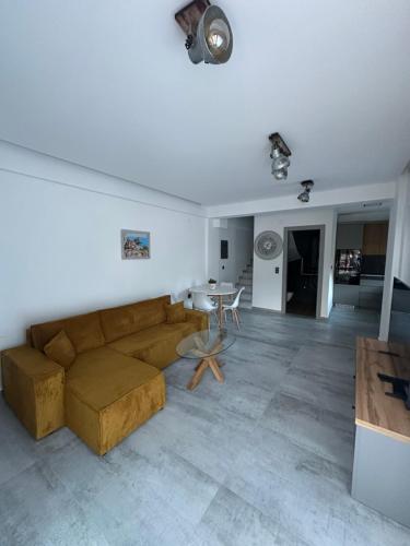 a living room with a couch and a table at Danielli Luxury Villas in Skala Rachoniou