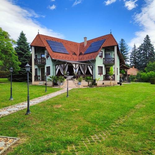 a house with a roof with solar panels on it at Balaton Garden in Balatongyörök