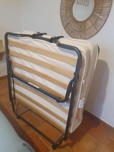 a towel rack with a mirror on a wall at Gîte des Falaises 10 à 12 personnes in Souspierre