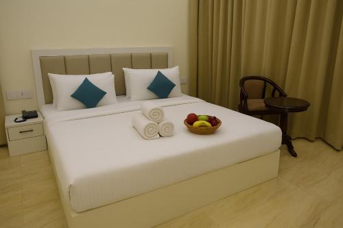 a bedroom with a bed with a bowl of fruit on it at Xenious Micro, Dharamshala in Dharmsala