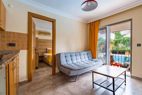 a living room with a couch and a table at Ten Apart Hotel in Fethiye