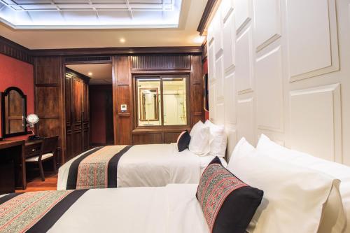 a hotel room with two beds and a desk at S48 River Ping in Chiang Mai