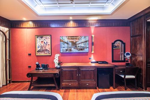 a room with a desk and a red wall at S48 River Ping in Chiang Mai