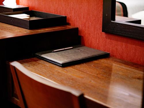 a laptop on a desk with a pen on it at S48 River Ping in Chiang Mai
