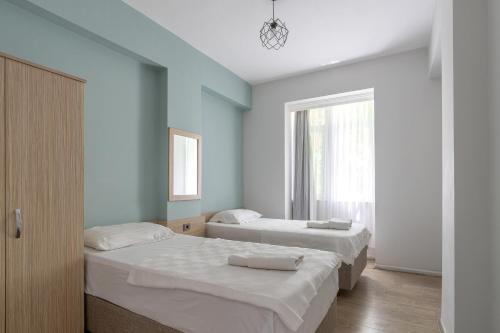 a bedroom with two beds and a window at Tunali Apart Hotel in Antalya