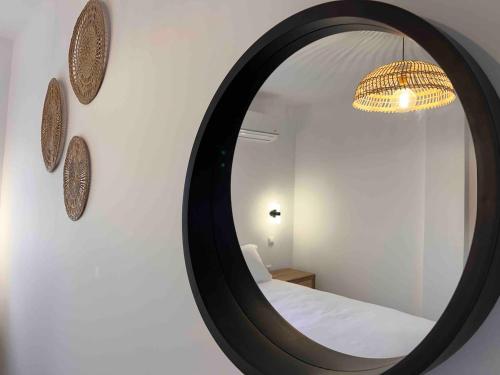 a mirror on a wall with a bed in a room at Villa Palios with private pool in Kardamaina