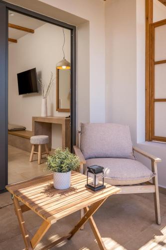 a living room with a couch and a table at Analeia Luxury Hotel - Adults Only in Kalymnos