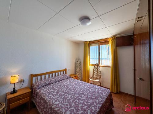 a bedroom with a bed and a window at Tossalet 37 in Oropesa del Mar