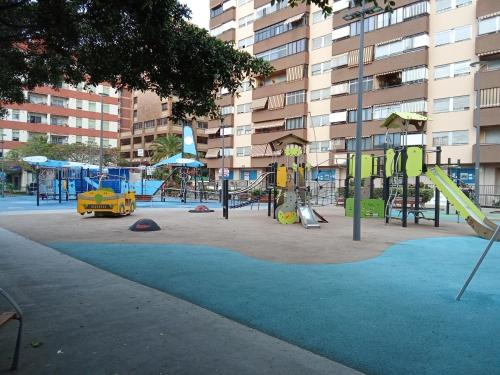 a playground with a slide and swings at Holiday home in Santa Cruz de Tenerife