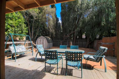 a patio with a table and chairs and a swing at Long stay Google BBQ BIG yard in Mountain View