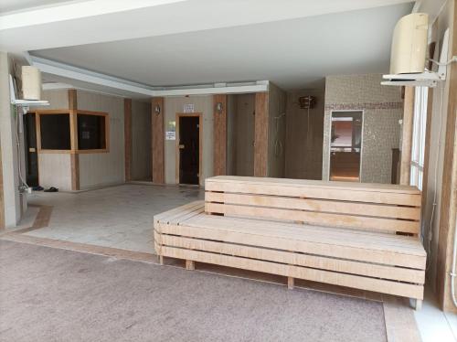 a room with wooden benches in a building at Casablanca Apartman in Hajdúszoboszló