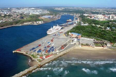 an aerial view of a harbor with a cruise ship at Portside Inn in East London