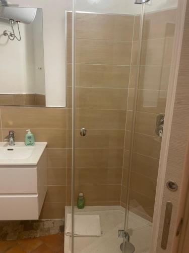 a shower with a glass door in a bathroom at Bellavista Rooms in Villasimius