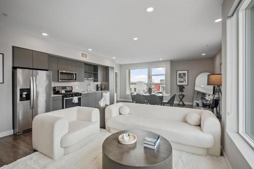 a living room with a couch and a table at Modern Luxury Oasis in WEHO Hollywood Sign Views in Los Angeles