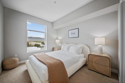 a white bedroom with a large bed and a window at Modern Luxury Oasis in WEHO Hollywood Sign Views in Los Angeles