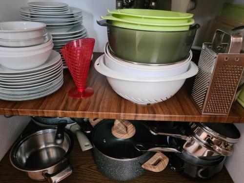 a shelf with plates and dishes in a kitchen at Slunečnice - Ubytování v soukromí na Třeboňsku in Třeboň