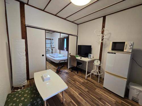 a small room with a desk and a computer in it at TSUBAME 101 staying private home in Osaka