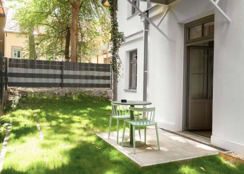 a table and two chairs in a yard at Limehome Graz Trauttmansdorffgasse in Graz